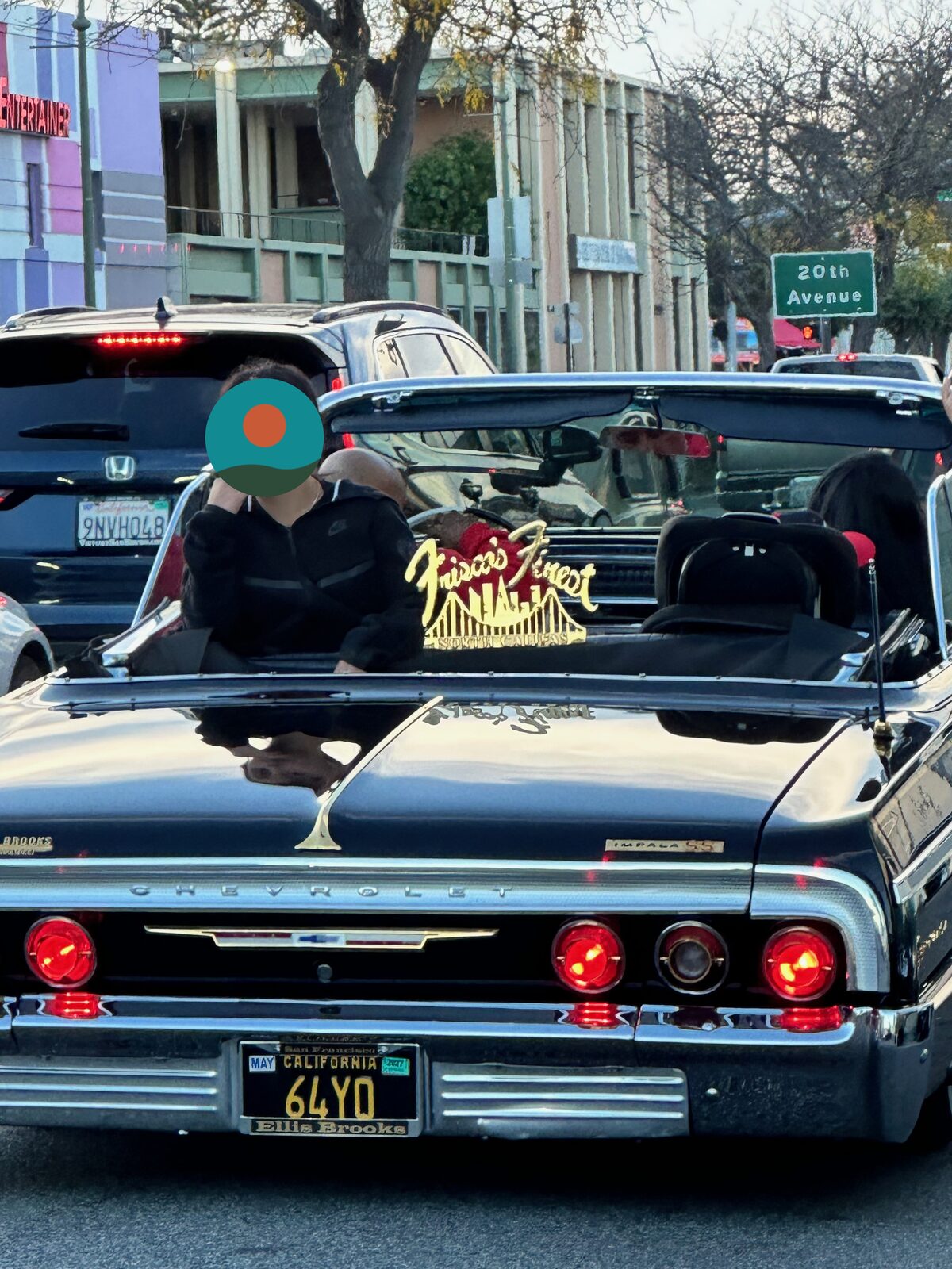 A black Impala convertible with a gold Friscos Finest car club plaque